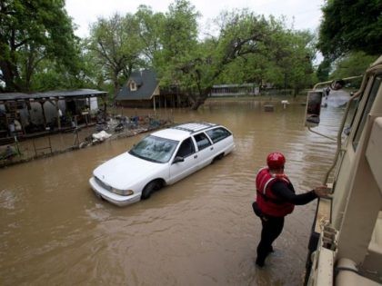 Army National Guard vehicles allow rescue workers to check on the welfare of residents who