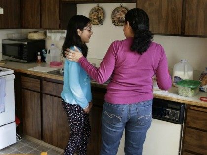 In this photo taken March 31, 2016, Teresa Garcia, right, helps her daughter, Alondra Miranda, 11, in Federal Way, Wash. Garcia has spent 14 years in the United States illegally after staying beyond the expiration of her tourist visa in 2002.