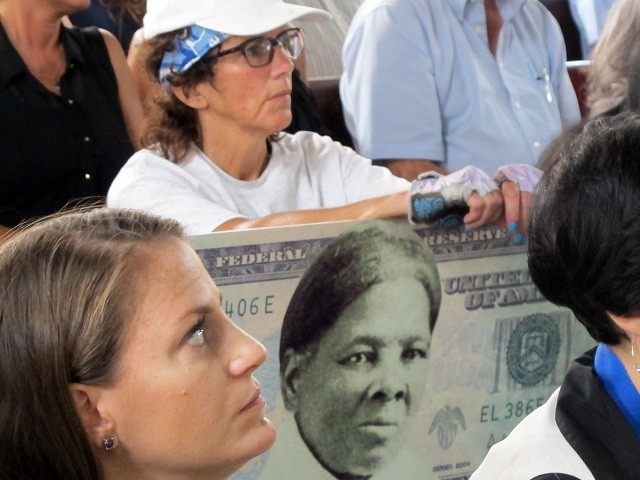 FILE - In this Monday, Aug. 31, 2015, file photo, a woman holds a sign supporting Harriet Tubman for the $20 bill during a town hall meeting at the Women's Rights National Historical Park in Seneca Falls, N.Y. A Treasury official said Wednesday, April 20, 2016, that Secretary Jacob Lew …