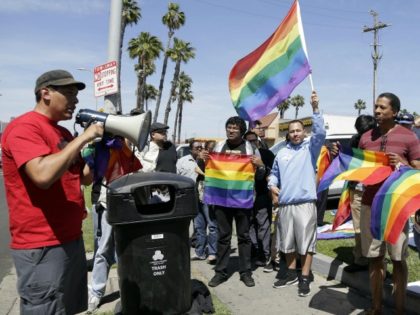 Students rally outside Santee Education Complex in South Los Angeles on Wednesday, April 20, 2016. The principal of the Los Angeles high school where a scuffle broke out with adult protesters over a new gender-neutral bathroom praised his students Wednesday as "trailblazers" for campaigning to install the restroom. (AP Photo/Nick …