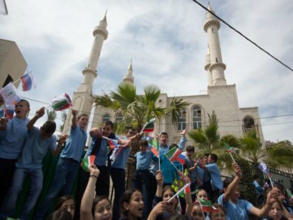 Residents of the Arab Israeli town of Abu Ghosh wave the Chechen flag during the dedication ceremony the new Akhmad Kadyrov mosque, on March 23 2014.