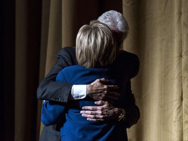 Bill and Hillary Clinton embrace (Andrew Renneisen / Getty)