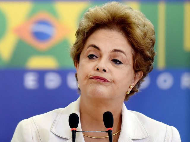 BRAZIL, Brasília : TOPSHOT - Brazilian President Dilma Rousseff gestures during the Education in Defense of Democracy event, at the Planalto Palace in Brasilia, on April 12, 2016. Rousseff entered the final straight Tuesday of a desperate battle to save her presidency ahead of an impeachment vote in Congress this …