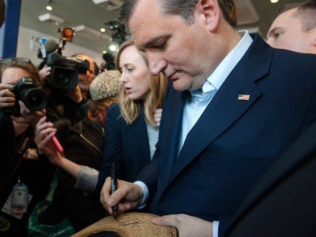 Republican presidential candidate Ted Cruz autographs a cowboy hat at the restaurant Sabro
