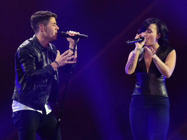 LOS ANGELES, CA - DECEMBER 05: Host Nick Jonas (L) and recording artist/actress Demi Lovato perform onstage during KIIS FM's Jingle Ball 2014 powered by LINE at Staples Center on December 5, 2014 in Los Angeles, California. (Photo by Kevin Winter/Getty Images for iHeartMedia)