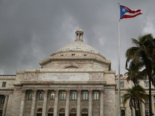 The Puerto Rican flag flies near the Capitol building as the island's residents deal with the government's $72 billion debt on July 1, 2015 in San Juan, Puerto Rico.