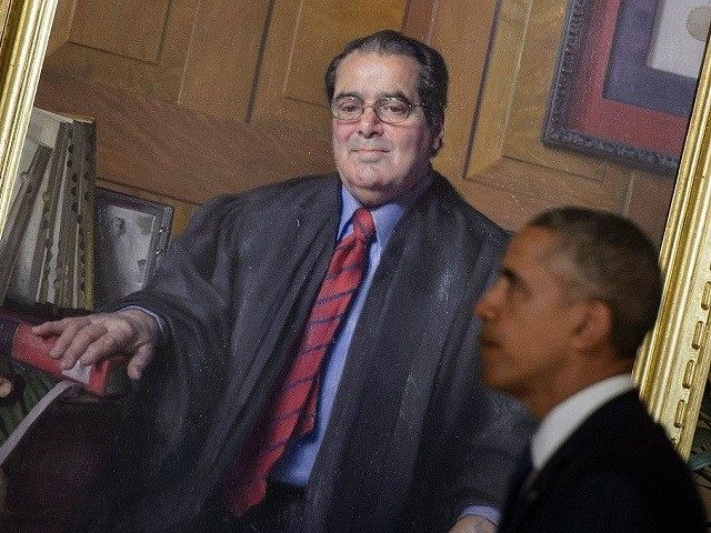 US President Barack Obama passes a portrait of Justice Antonin Scalia after paying respect