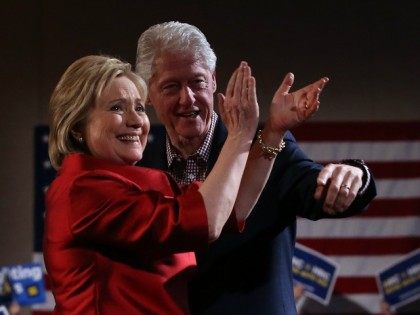 Democratic presidential candidate former Secretary of State Hillary Clinton and her husband former U.S. president Bill Clinton greet supporters during a caucus day event at Caesers Palace on February 20, 2016 in Las Vegas, Nevada.