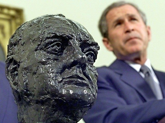 President George W. Bush listens to journalists' questions after receiving a bust of