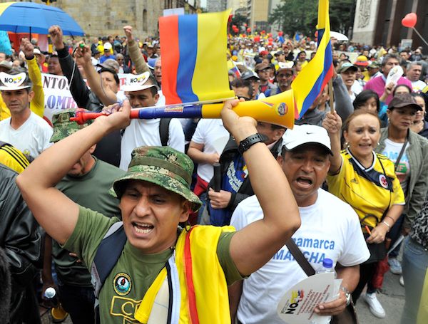 People take part in the "No More" march against the government of President Juan Manuel Santos and the Revolutionary Armed Forces of Colombia (FARC) guerrillas in Bogota, on April 2, 2016. The government of President Santos and the FARC have been holding peace talks for three years to end a half-century guerrilla war that has killed more than 260,000 people. AFP PHOTO / GUILLERMO LEGARIA / AFP / GUILLERMO LEGARIA (Photo credit should read GUILLERMO LEGARIA/AFP/Getty Images)