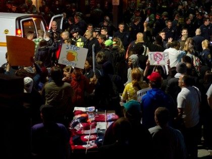 Protesters argue with Donald Trump supporters after a rally at the David Lawrence Conventi