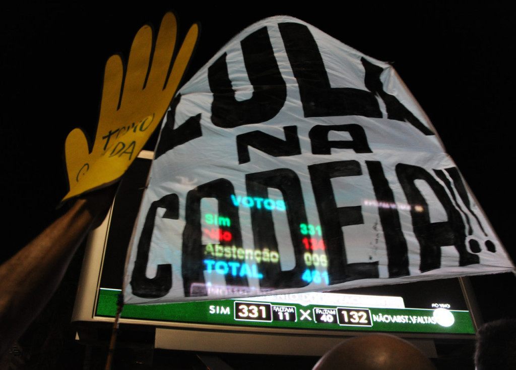 Supporters of the impeachment of Brazilian President Dilma Rousseff follow on big screens in Rio de Janeiro, Brazil, as lawmakers get close to be votes needed to authorize her impeachment to go ahead, on April 17, 2016. Brazilian lawmakers on Sunday reached the two thirds majority necessary to authorize impeachment proceedings against President Dilma Rousseff. The lower house vote sends Rousseff's case to the Senate, which can vote to open a trial. A two thirds majority in the upper house would eject her from office. Rousseff, whose approval rating has plunged to a dismal 10 percent, faces charges of embellishing public accounts to mask the budget deficit during her 2014 reelection. / AFP / TASSO MARCELO (Photo credit should read TASSO MARCELO/AFP/Getty Images)