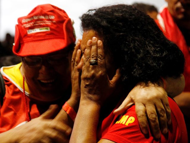 Supporters of Brazilian President Dilma Rousseff show their dejection after lawmakers authorized her impeachment to go ahead, in front of the National Congress in Brasilia, on April 17, 2016. Brazilian lawmakers on Sunday reached the two thirds majority necessary to authorize impeachment proceedings against President Dilma Rousseff. The lower house vote sends Rousseff's case to the Senate, which can vote to open a trial. A two thirds majority in the upper house would eject her from office. Rousseff, whose approval rating has plunged to a dismal 10 percent, faces charges of embellishing public accounts to mask the budget deficit during her 2014 reelection. / AFP / BETO BARATA (Photo credit should read BETO BARATA/AFP/Getty Images)
