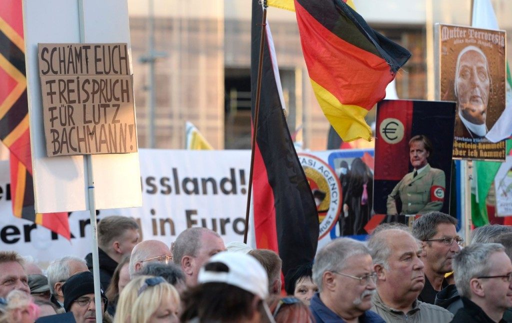 A poster reads 'Shame on you. Free speech for Lutz Bachmann' during the far-right PEGIDA movement (Patriotic Europeans Against the Islamisation of the Occident) rally on April 18, 2016 in Dresden. Bachmann, founder of the far-right, is due to face court tomorrow on hate speech charges for branding refugees "cattle" and "scum" on social media. / AFP / ROBERT MICHAEL (Photo credit should read ROBERT MICHAEL/AFP/Getty Images)