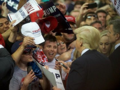 Republican Presidential candidate Donald Trump signs autographs for supporters following a