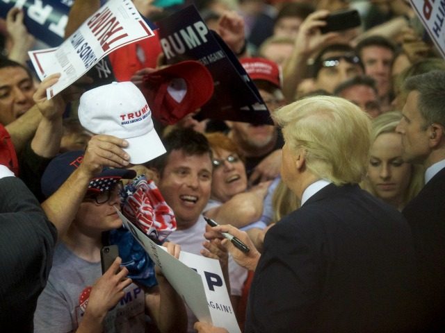 Republican Presidential candidate Donald Trump signs autographs for supporters following a