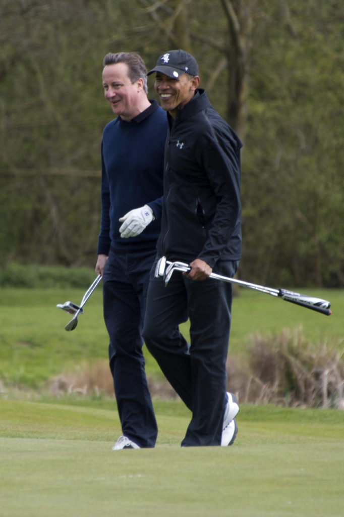 US President Barack Obama (R) talks with British Prime Minister David Cameron (L) as they walk onto the 3rd green at The Grove Golf Course near Watford in Hertfordshire, north of London, on April 23, 2016. 
