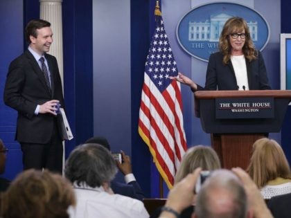 Actress Allison Janney (R) speaks as she shows up to surprise members of the press crops at the James Brady Press Briefing Room of the White House as press secretary Josh Earnest (L) looks on April 29, 2016 in Washington, DC