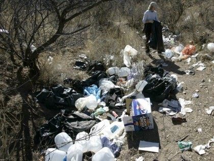 A volunteer picks up trash on a immigrant passage near Arivaca, Arizona. File.