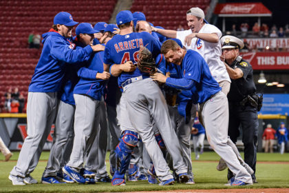 CINCINNATI, OH - APRIL 21: The Chicago Cubs and a fan celebrate with Jake Arrieta #49 of