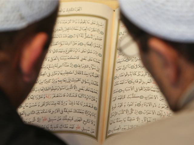 BERLIN - OCTOBER 03: Muslim men study the Koran at the Sehitlik Mosque on open house day a