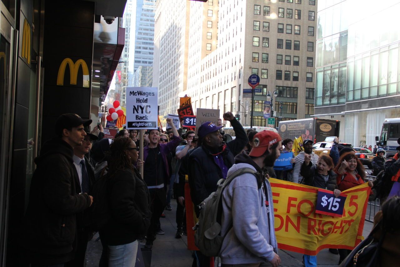 Fight for 15 protesters stop the march outside of McDonald's and begin chanting