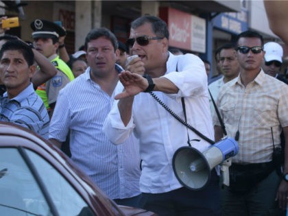 Ecuadorean President Rafael Correa (C) visits a disaster area in Montecristi, Ecuador on April 19, 2016. At least 413 people were killed when a powerful earthquake struck Ecuador on Saturday, destroying buildings and a bridge and sending terrified residents scrambling from their homes, authorities said Sunday. / AFP / Juan …