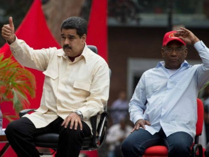 Venezuela’s President Nicolas Maduro flashes a thumbs up sitting next to Vice President