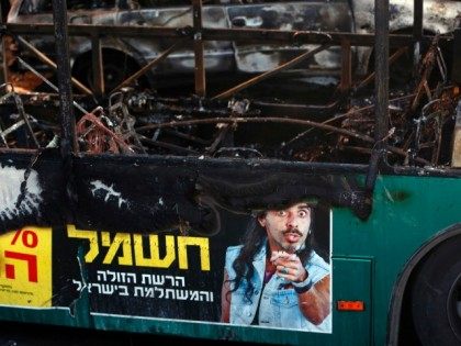 general view shows the remains of a bus following a bomb blast on board in Jerusalem on Ap