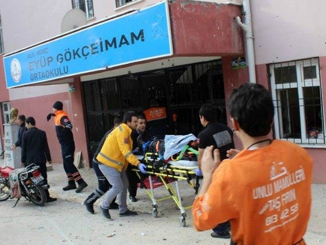 Emergency services evacuate an injured man on a stretcher on January 18, 2016 after mortar