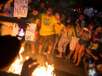 Protesters against Dilma Rousseff, Brazil's president, burn a figure in Rousseff's likeness after watching a televised broadcast of the country's lower house of Congress voting in favor of Rousseff's impeachment at Copacabana Beach in Rio de Janeiro, Brazil, on Sunday, April 17, 2016. Rousseff's presidency is hanging by a thread …