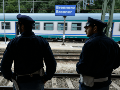 Italian police officers (Carrabinieri) wait for a train heading north to Munich at the Brenner Pass on September 3, 2015 in Brennero, Italy.