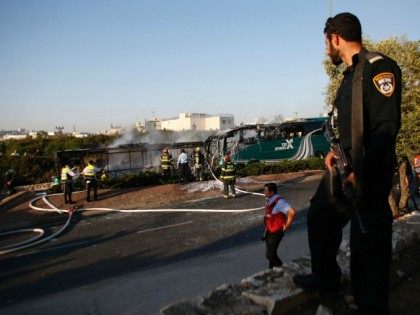 Israeli forensic and firefighters work at the scene of an explosion on a bus in Jerusalem