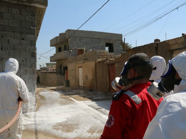 Members of the civil defence spray and clean areas in the town of Taza, around 220 kilomet