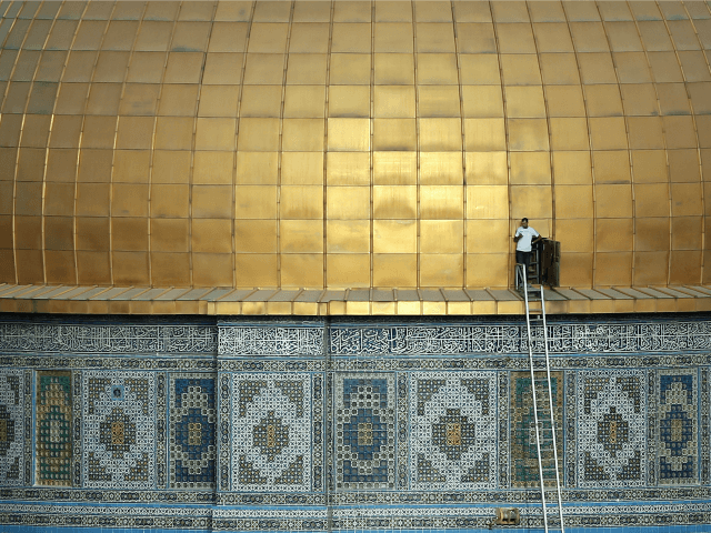 A Palestinian man stands by a door at the golden dome of the Dome of the Rock mosque on the Al-Aqsa mosque compound, in Jerusalem's Old City, on September 29, 2015.