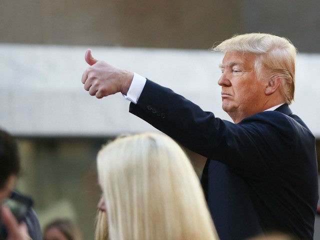 Republican presidential candidate Donald Trump waves to members of the audience while appe