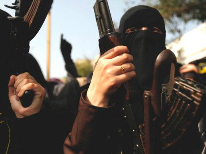 Palestinian female militants of the Islamic Jihad hold their weapons during a rally markin