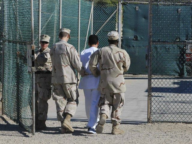 US Navy guards escort a detainee through Camp Delta, June 10, 2008. REUTERS/DOD/1ST LT. SARAH CLEVELAND