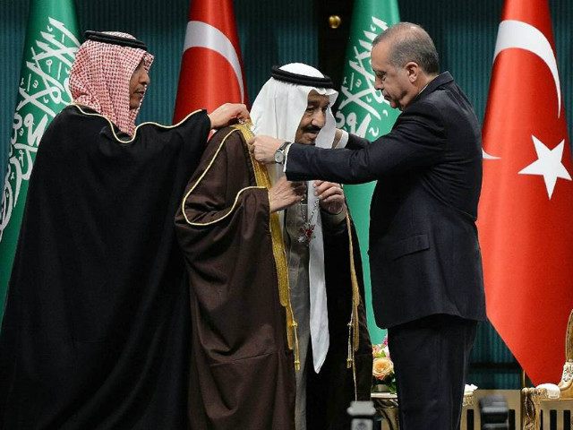 Turkish President Recep Tayyip Erdogan (R) presents Turkey's highest state …