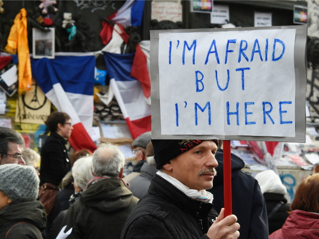 A man holding a placard reading 'I am afraid but I am here' during a gathering on Place de la Republique (Republic square) on January 10, 2016 in Paris, as the city marks a year since 1.6 million people thronged the French capital in a show of unity after attacks …