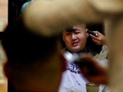 Australian Chinese Howard, 34, who does not disclose his last name, undergoes a haircut be