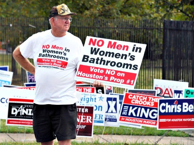 File - In this Oct. 21, 2015 file photo, a man urges people to vote against the Houston Equal Rights Ordinance outside an early voting center in Houston. On Tuesday, Nov. 3, 2015, voters statewide can give themselves tax breaks, pump billions of dollars into roads and make hunting and …