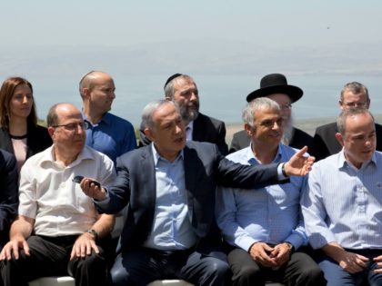 Israeli Prime Minister Benjamin Netanyahu (C) poses with ministers prior to the weekly cabinet meeting in the Israeli-annexed Golan Heights on April 17, 2016.
