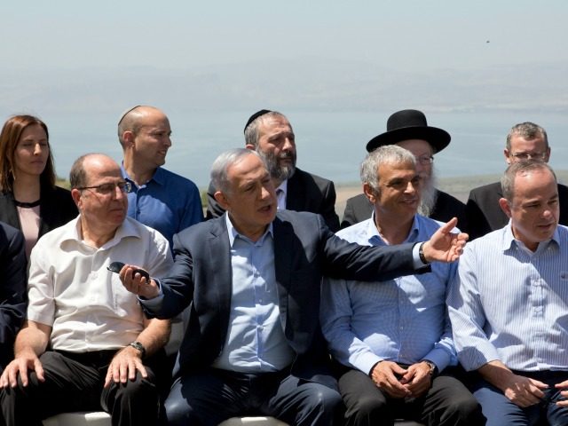 Israeli Prime Minister Benjamin Netanyahu (C) poses with ministers prior to the weekly cab