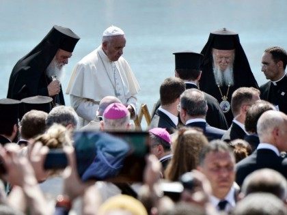 Pope Francis (C) Ecumenical Patriarch Bartholomew (R) and Greece's Archbishop (R) attend a