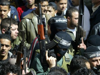 Gunmen take part in the funeral of four of the fivePalestinians killed during yesterday's Israeli army incursion into the Balata refugee camp, in the West Bank city of Nablus 24 February.