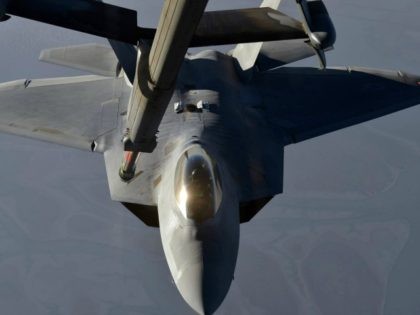 In this handout image provided by the U.S. Air Force, A KC-10 Extender refuels an F-22 Raptor fighter aircraft prior to strike operations in Syria, during flight on September 23, 2014.