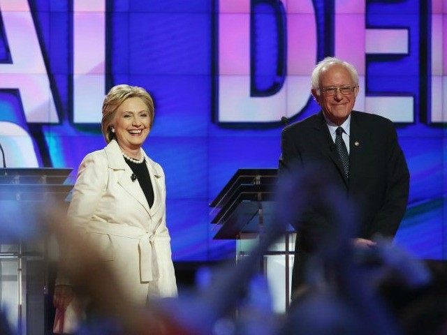 Democratic Presidential candidates Hillary Clinton and Sen. Bernie Sanders (D-VT) stand on