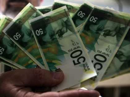 An employee of Bank of Israel holds new 50 Shekels' bills during a press conference a