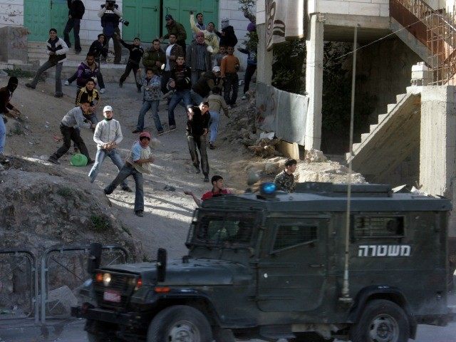 Palestinian youths throw stones at Israeli border police during clashes after Friday praye